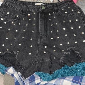 Black denim shorts with diamonds on the front